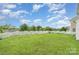 Expansive backyard featuring a lush lawn and white picket fence at 3244 Oulten Sw St, Concord, NC 28027