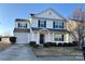 Two-story home features white siding, black shutters, a one-car garage, and a well-manicured front yard at 3244 Oulten Sw St, Concord, NC 28027