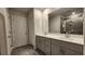 Bathroom featuring double sinks, gray cabinets, and a glass-enclosed shower at 332 Cranford Dr, Pineville, NC 28134