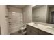 Bright bathroom with double vanity, gray cabinets, and shower/tub combo at 332 Cranford Dr, Pineville, NC 28134
