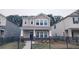 Charming two-story home with neutral siding and a well-manicured lawn, all enclosed by a sleek, black fence at 332 Cranford Dr, Pineville, NC 28134