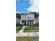 Beautiful two-story house featuring a manicured lawn, a decorative black fence, and a welcoming entrance at 332 Cranford Dr, Pineville, NC 28134