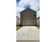 Spacious two-car garage with ample driveway space and modern lighting, perfect for convenient parking at 332 Cranford Dr, Pineville, NC 28134