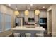 Modern kitchen featuring stainless steel appliances and stylish pendant lights over the island at 332 Cranford Dr, Pineville, NC 28134