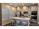 Modern kitchen with stainless steel appliances, gray cabinets, white countertops, and pendant lighting at 332 Cranford Dr, Pineville, NC 28134