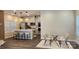 Open-concept kitchen with island seating flowing into dining area with glass table at 332 Cranford Dr, Pineville, NC 28134