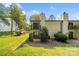 Two-story townhome with a spacious grassy backyard and small balcony at 3737 Winding Creek Ln, Charlotte, NC 28226