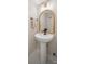 Bathroom featuring pedestal sink, rattan framed mirror and hexagon tile flooring at 3737 Winding Creek Ln, Charlotte, NC 28226