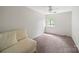 Bright bedroom featuring large window and neutral decor at 3737 Winding Creek Ln, Charlotte, NC 28226