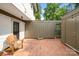 Charming brick-paved courtyard with string lights, offers a cozy outdoor space for relaxation and entertaining at 3737 Winding Creek Ln, Charlotte, NC 28226