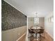 Elegant dining room with stylish wallpaper, modern chandelier, and seating for four at 3737 Winding Creek Ln, Charlotte, NC 28226