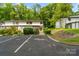 Beautiful townhome featuring lush landscaping, reserved parking, and an inviting exterior at 3737 Winding Creek Ln, Charlotte, NC 28226