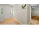 Entryway featuring wood-look floors, coat hooks, and a decorated wall at 3737 Winding Creek Ln, Charlotte, NC 28226