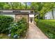 Inviting exterior featuring stone accents, lush landscaping, and a charming walkway leading to the front door at 3737 Winding Creek Ln, Charlotte, NC 28226