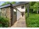 Charming home exterior with stone and siding, a covered entrance, and well-manicured landscaping at 3737 Winding Creek Ln, Charlotte, NC 28226