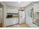 Bright kitchen featuring white cabinets, granite countertops, and stainless steel microwave and refrigerator at 3737 Winding Creek Ln, Charlotte, NC 28226