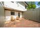 Charming brick patio with wooden chairs and decorative string lights at 3737 Winding Creek Ln, Charlotte, NC 28226