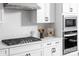 Modern kitchen with stainless steel appliances, white cabinets, a diamond-patterned backsplash, and ample counter space at 4146 Eastover Glen Rd # 0322, Charlotte, NC 28269