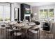 Spacious open-concept living and dining area with hardwood floors, modern fireplace, large windows, and an outdoor patio beyond at 4146 Eastover Glen Rd # 0322, Charlotte, NC 28269