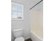 Bathroom featuring a white toilet and shower/tub with a large window at 4208 Coulter Xing, Charlotte, NC 28213