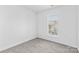Bedroom with neutral carpet, a bright window, and electrical outlets on the walls at 4208 Coulter Xing, Charlotte, NC 28213