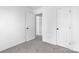 Bedroom showing neutral walls and carpet, two doors, and white trim at 4208 Coulter Xing, Charlotte, NC 28213