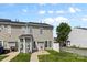Rear exterior showcasing neutral siding, white trim, and a well-maintained yard at 4208 Coulter Xing, Charlotte, NC 28213