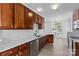This bright kitchen offers white quartz countertops, dark cabinets, and stainless steel dishwasher at 4208 Coulter Xing, Charlotte, NC 28213