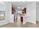 Modern kitchen with hardwood floors, white countertops, and dark cabinets opens to the living room at 4208 Coulter Xing, Charlotte, NC 28213