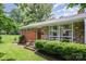 Charming home with a brick and stone facade, well-manicured lawn, and lush landscaping at 4232 Randolph Rd, Charlotte, NC 28211