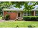 Charming brick and stone home with a well-manicured lawn, inviting entrance, and beautiful landscaping at 4232 Randolph Rd, Charlotte, NC 28211