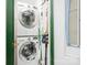 Laundry area featuring stacked washer and dryer, plus storage at 4232 Randolph Rd, Charlotte, NC 28211
