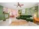 Spacious living room with vibrant green walls, unique decor, and an adjacent dining area at 4232 Randolph Rd, Charlotte, NC 28211