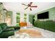 Bright living room with a green accent wall, white floors, and stylish furnishings at 4232 Randolph Rd, Charlotte, NC 28211
