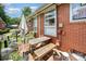 Private patio area with brick exterior, dining set, and shade umbrella, perfect for outdoor living at 4232 Randolph Rd, Charlotte, NC 28211