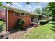 Charming home with a brick and stone facade, well-manicured lawn, and mature landscaping at 4232 Randolph Rd, Charlotte, NC 28211