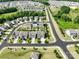 Aerial view features homes, well-maintained lawns, and a street lined with trees at 4310 Coachwhip Ave, Lancaster, SC 29720
