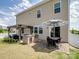 Home's backyard offers an outdoor kitchen under a pergola, with a dining set on a brick patio at 4310 Coachwhip Ave, Lancaster, SC 29720