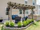 Outdoor patio area with pergola, outdoor seating, and lush landscaping, perfect for entertaining at 4310 Coachwhip Ave, Lancaster, SC 29720