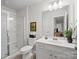 Bright bathroom featuring a glass shower and vanity with storage, plus neutral wall art at 4310 Coachwhip Ave, Lancaster, SC 29720