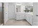 Bright bathroom featuring dual sinks, white cabinets, and large mirror at 4310 Coachwhip Ave, Lancaster, SC 29720