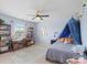 Light blue bedroom with ceiling fan, desk and bookshelves at 4310 Coachwhip Ave, Lancaster, SC 29720