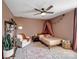 Cozy bedroom features a ceiling fan, a plush armchair, and a comfortable bed with soft lighting at 4310 Coachwhip Ave, Lancaster, SC 29720