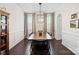 Formal dining room with dark wood floors, wainscoting, elegant curtains, and a stylish chandelier at 4310 Coachwhip Ave, Lancaster, SC 29720