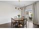 Cozy dining room featuring a wooden table, chandelier, and sliding glass doors to outdoor patio at 4310 Coachwhip Ave, Lancaster, SC 29720