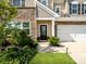 Charming home featuring a stone facade, manicured bushes, and a tidy front lawn leading to the front entrance at 4310 Coachwhip Ave, Lancaster, SC 29720