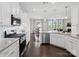 Modern kitchen with stainless appliances, white cabinetry, and adjacent dining area creating a seamless flow at 4310 Coachwhip Ave, Lancaster, SC 29720