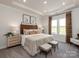 This main bedroom has neutral decor, carpet, and a large window at 438 Bent Burr Crk, York, SC 29745