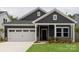 Charming home featuring a two-car garage, neat landscaping, and a welcoming covered front porch at 438 Bent Burr Crk, York, SC 29745