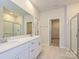 Well-lit bathroom with a double sink vanity, tile flooring, and a glass-enclosed shower at 450 Bent Burr Crk, York, SC 29745